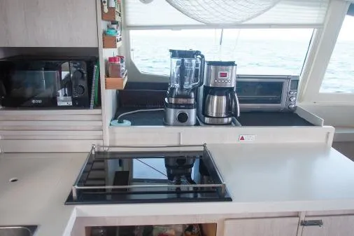 Pilar Yacht Photos Pics Modern kitchen in 2015 Leopard 48 yacht with appliances and ocean view.