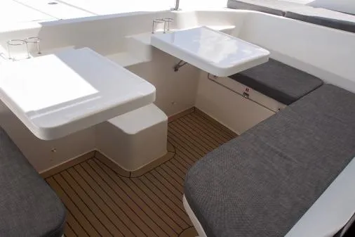 Pilar Yacht Photos Pics 2015 Robertson & Caine Leopard 48 yacht interior with seating and tables, featuring sleek design.
