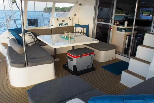 Pilar Yacht Photos Pics 2015 Robertson & Caine Leopard 48 yacht interior with seating, table, and ocean view.