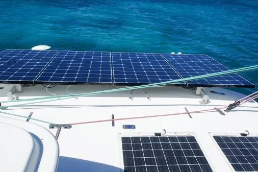 Pilar Yacht Photos Pics 2015 Robertson & Caine Leopard 48 yacht with solar panels on deck, sailing in clear blue waters.