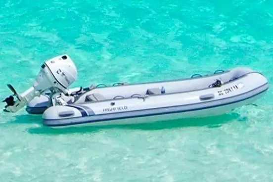 Pilar Yacht Photos Pics Inflatable boat with outboard motor on clear turquoise water, 2015 Robertson & Caine Leopard 48.