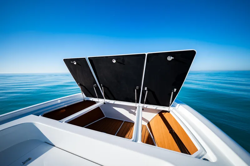  Yacht Photos Pics 2016 Barker Boatworks 26 Calibogue Bay with open storage compartments on calm sea.