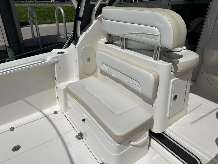 Last One II Yacht Photos Pics 2015 Wellcraft 290 Coastal boat interior with white cushioned seating and storage.