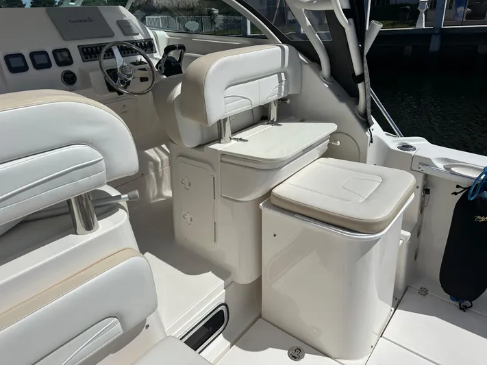 Last One II Yacht Photos Pics 2015 Wellcraft 290 Coastal boat interior with white seating and helm station.