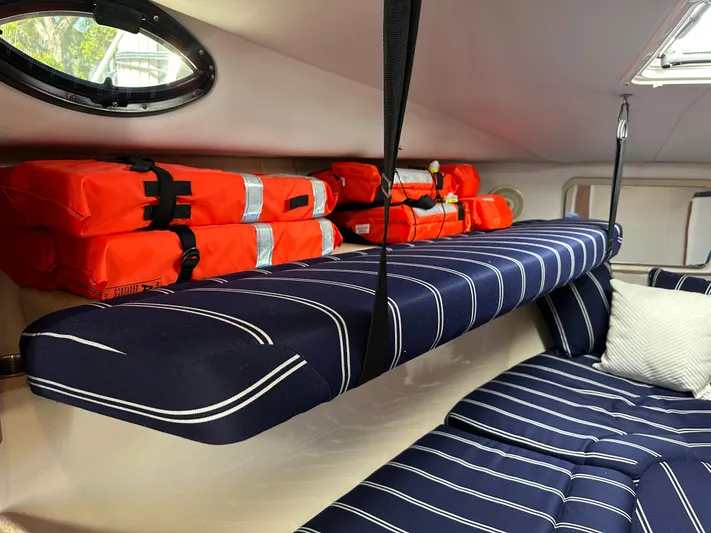 Last One II Yacht Photos Pics Interior of 2015 Wellcraft 290 Coastal boat with striped cushions and orange life jackets.