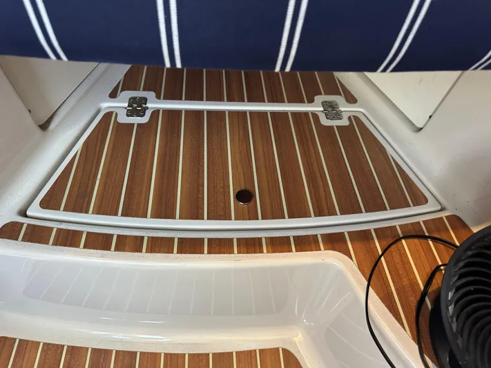 Last One II Yacht Photos Pics Teak deck of 2015 Wellcraft 290 Coastal boat with striped seating.