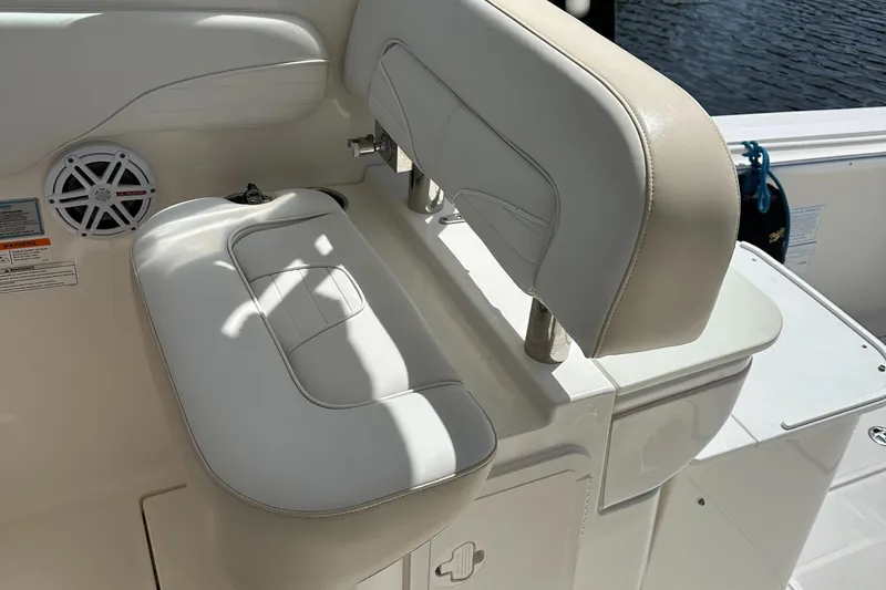Last One II Yacht Photos Pics 2015 Wellcraft 290 Coastal boat seat with white upholstery and speaker detail.