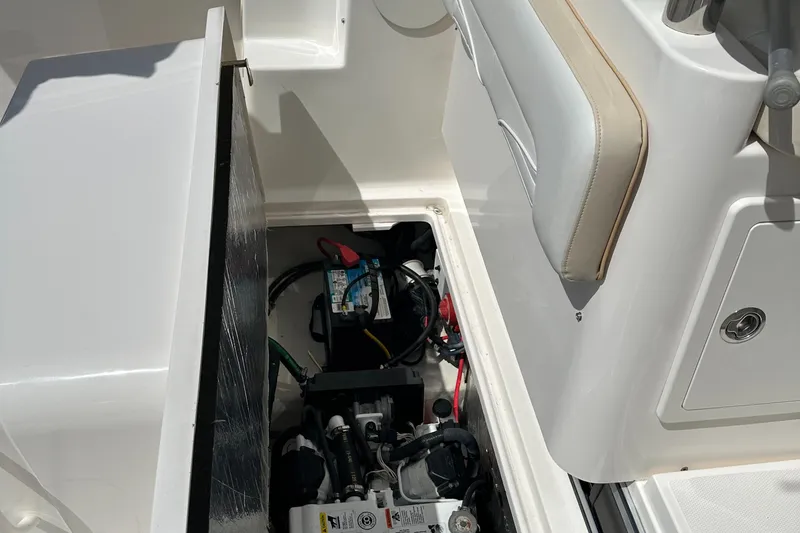Last One II Yacht Photos Pics 2015 Wellcraft 290 Coastal boat battery compartment with wiring and components.
