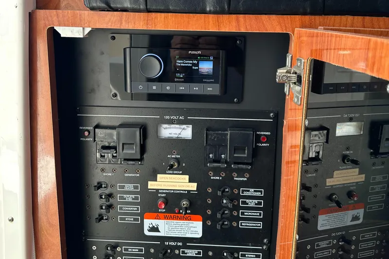 Last One II Yacht Photos Pics Control panel of a 2015 Wellcraft 290 Coastal boat with audio system and switches.