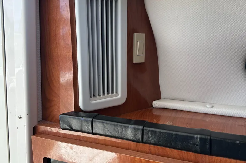 Last One II Yacht Photos Pics Interior detail of 2015 Wellcraft 290 Coastal boat, featuring wood paneling and ventilation.