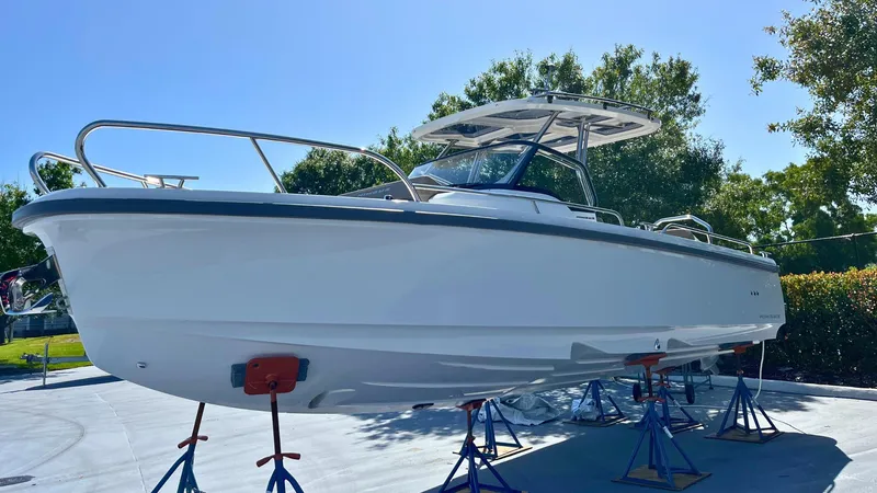 In-stock 2024 Nimbus T8 #314 Yacht Photos Pics 2024 Nimbus Tender 8 #314 boat on stands, outdoors, under clear blue sky.