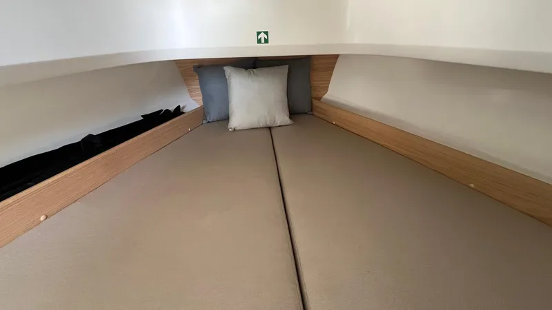 In-stock 2024 Nimbus T8 #314 Yacht Photos Pics 2024 Nimbus Tender 8 #314 cabin interior with cozy bedding and cushions.