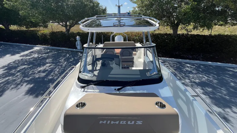 In-stock 2024 Nimbus T8 #314 Yacht Photos Pics 2024 Nimbus Tender 8 #314 boat, sleek design, parked outdoors under trees.