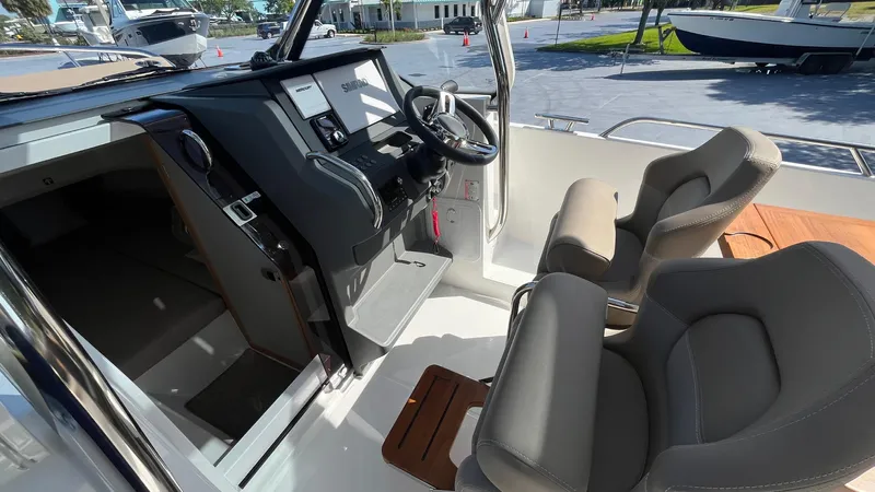 In-stock 2024 Nimbus T8 #314 Yacht Photos Pics 2024 Nimbus Tender 8 #314 boat interior with modern steering and comfortable seating.