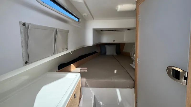In-stock 2024 Nimbus T8 #314 Yacht Photos Pics 2024 Nimbus Tender 8 #314 cabin interior with bed and storage compartments.