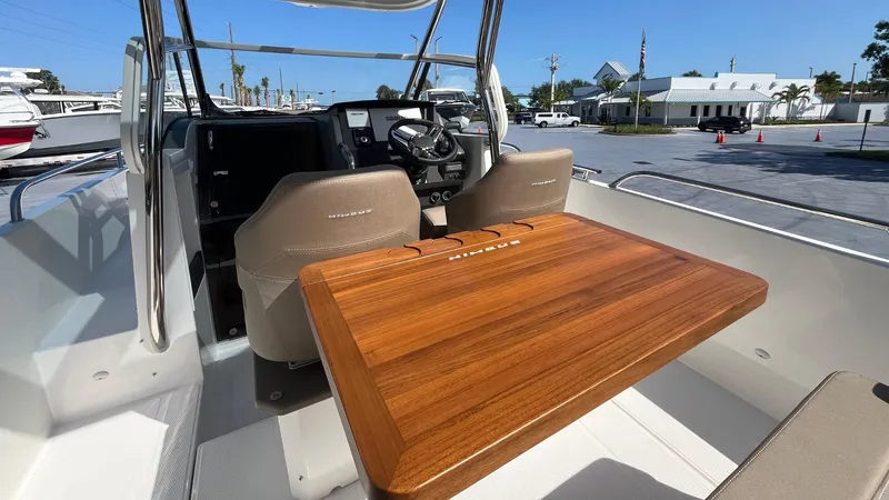 In-stock 2024 Nimbus T8 #314 Yacht Photos Pics 2024 Nimbus Tender 8 #314 boat interior with wooden table and steering console.