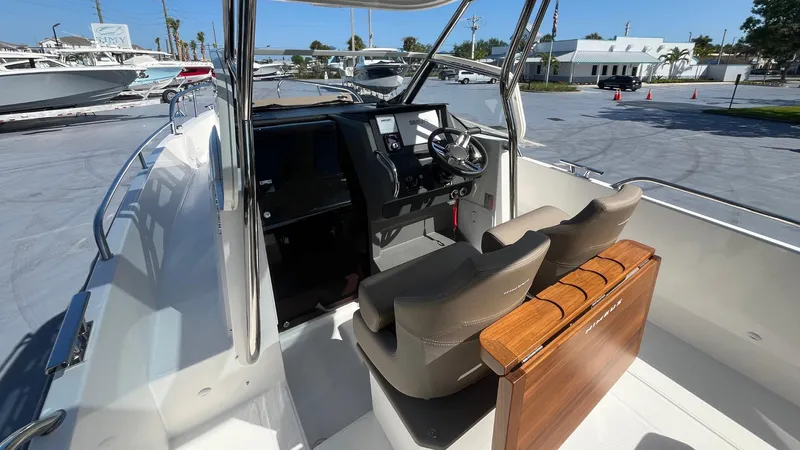 In-stock 2024 Nimbus T8 #314 Yacht Photos Pics 2024 Nimbus Tender 8 #314 boat interior with dual seats and steering console.