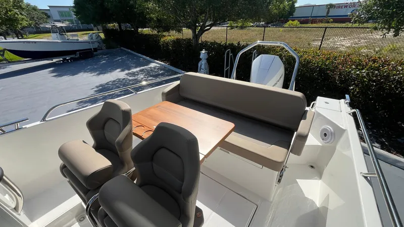 In-stock 2024 Nimbus T8 #314 Yacht Photos Pics 2024 Nimbus Tender 8 #314 boat interior with seating and table, outdoor setting.