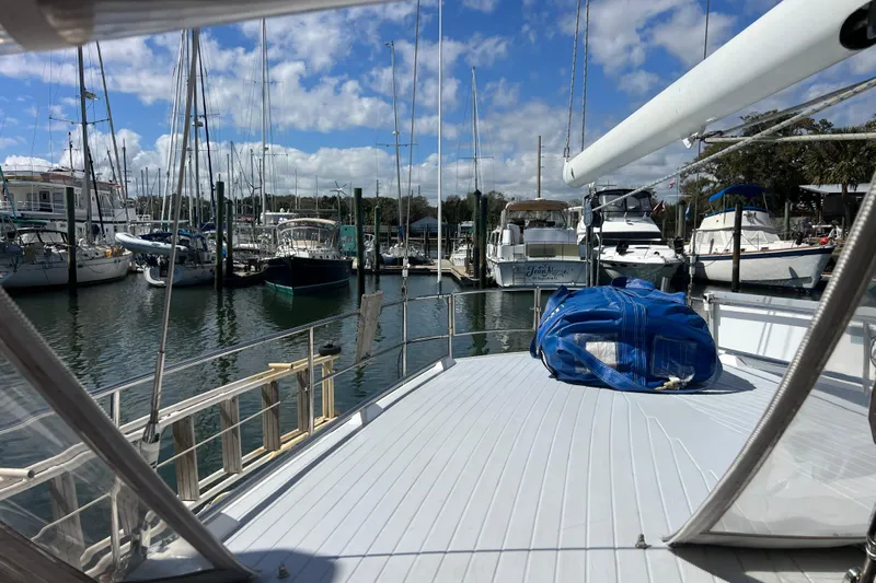 Hobo Tiempo Yacht Photos Pics 1986 Amel Mango sailboat docked in a marina under a blue sky.