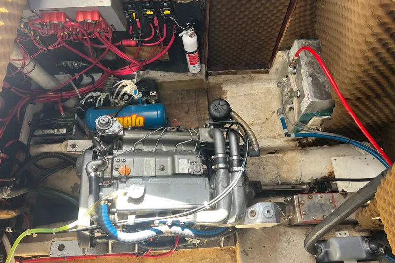 Hobo Tiempo Yacht Photos Pics Engine room of a 1986 Amel Mango sailboat with visible wiring and components.