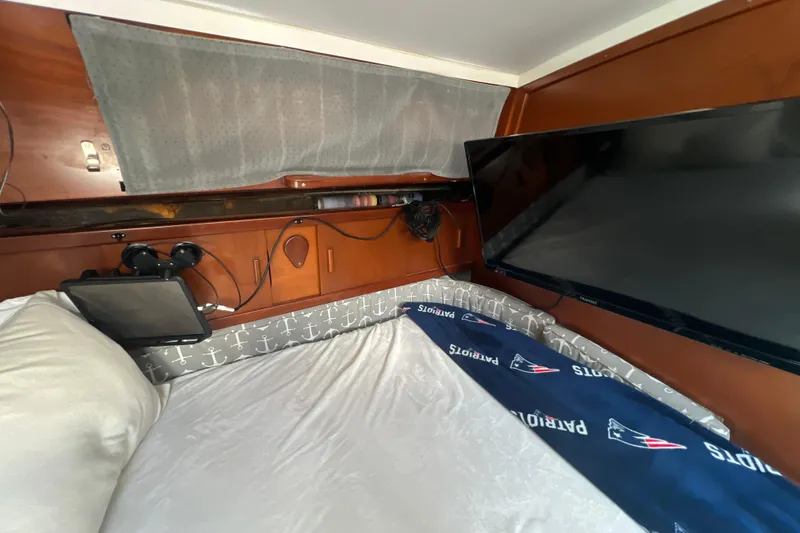 Hobo Tiempo Yacht Photos Pics Cozy cabin interior of 1986 Amel Mango yacht with TV and nautical decor.