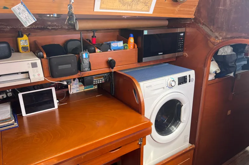 Hobo Tiempo Yacht Photos Pics Interior of 1986 Amel Mango yacht with washing machine, microwave, and navigation equipment.
