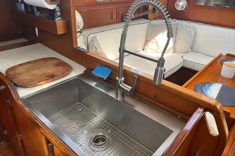 Hobo Tiempo Yacht Photos Pics Galley of 1986 Amel Mango yacht with stainless steel sink and cozy seating area.