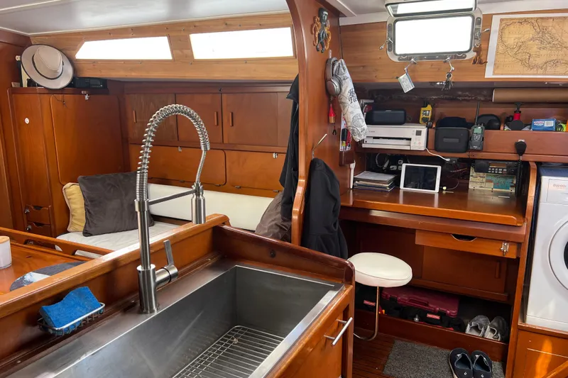 Hobo Tiempo Yacht Photos Pics Interior of 1986 Amel Mango sailboat with wooden cabinetry and modern amenities.
