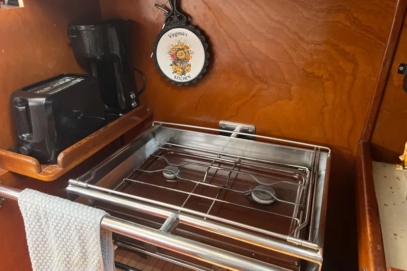 Hobo Tiempo Yacht Photos Pics Compact kitchen in 1986 Amel Mango boat with stove, toaster, and coffee maker.