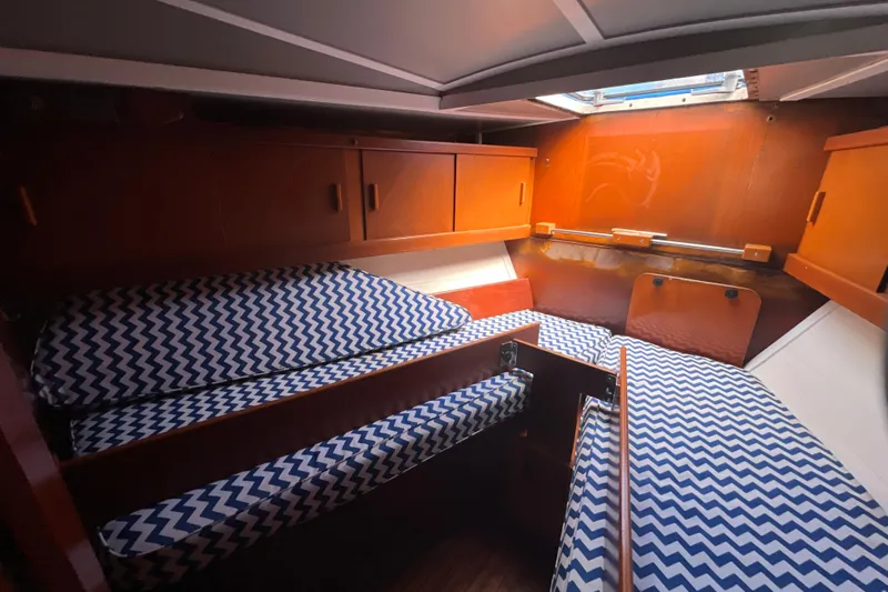Hobo Tiempo Yacht Photos Pics Cozy cabin interior of 1986 Amel Mango sailboat with zigzag patterned cushions.
