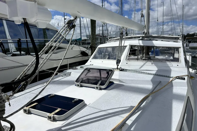Hobo Tiempo Yacht Photos Pics 1986 Amel Mango sailboat deck with rigging, docked at marina under cloudy sky.