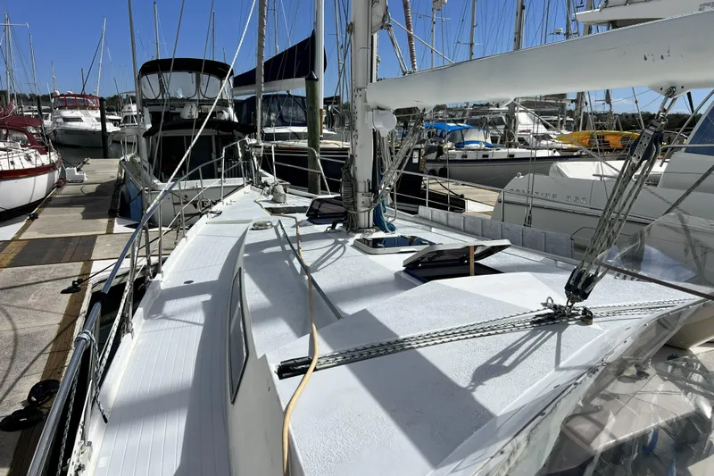 Hobo Tiempo Yacht Photos Pics 1986 Amel Mango sailboat docked at a marina, surrounded by other boats.