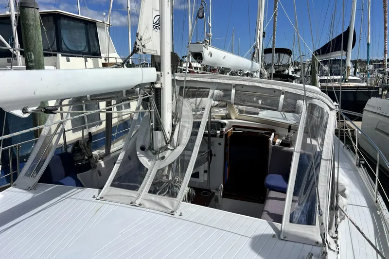 Hobo Tiempo Yacht Photos Pics 1986 Amel Mango sailboat docked at marina, featuring cockpit and rigging.