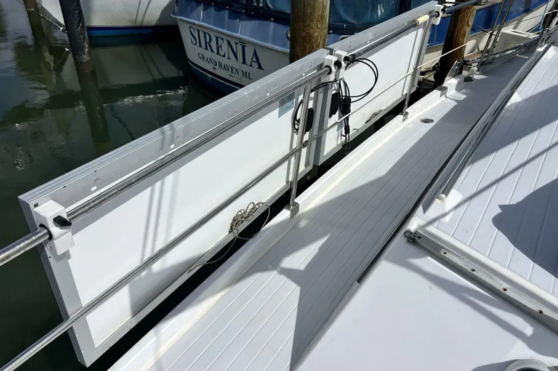 Hobo Tiempo Yacht Photos Pics Deck of 1986 Amel Mango sailboat with docked boat in background.