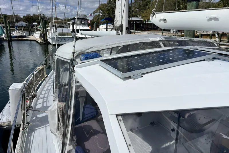 Hobo Tiempo Yacht Photos Pics 1986 Amel Mango sailboat with solar panel docked at marina.