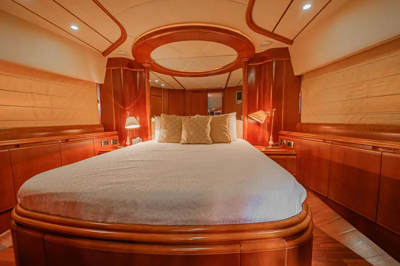 Isabella K Yacht Photos Pics Luxurious bedroom interior of 2002 Astondoa 72 GLX yacht with elegant wood finishes.