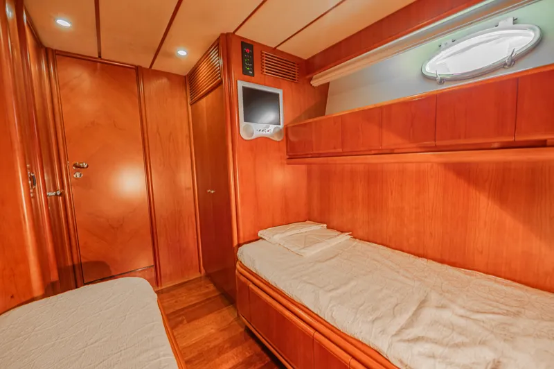 Isabella K Yacht Photos Pics Luxurious cabin interior of 2002 Astondoa 72 GLX yacht with twin beds and wood finish.