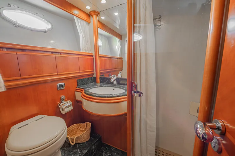 Isabella K Yacht Photos Pics Luxurious bathroom in 2002 Astondoa 72 GLX yacht with wood accents and modern fixtures.