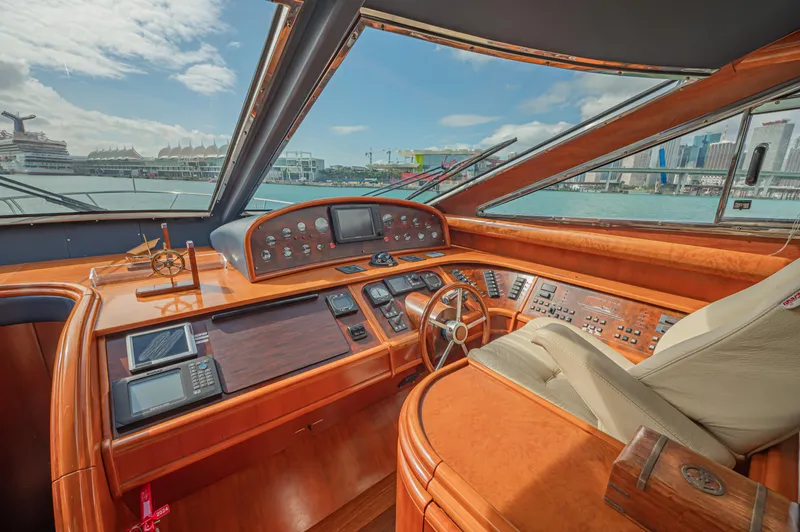 Isabella K Yacht Photos Pics Luxurious helm of 2002 Astondoa 72 GLX yacht with cityscape view.