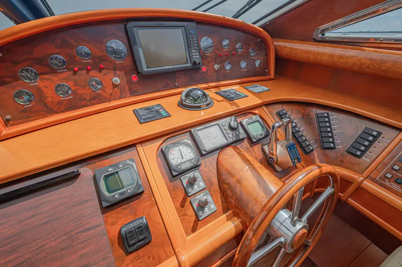 Isabella K Yacht Photos Pics Luxurious 2002 Astondoa 72 GLX yacht helm with wood finish and advanced navigation instruments.
