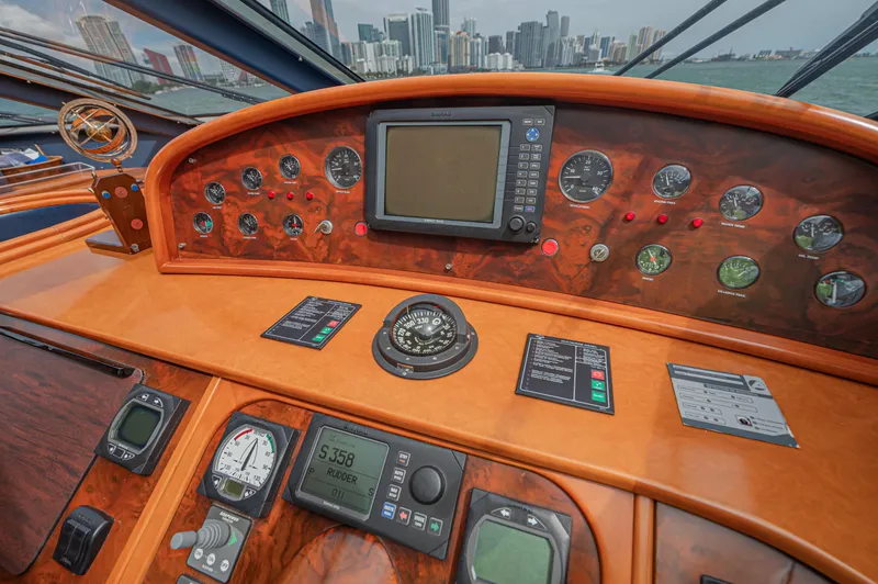 Isabella K Yacht Photos Pics Helm of 2002 Astondoa 72 GLX yacht with navigation instruments and city skyline view.