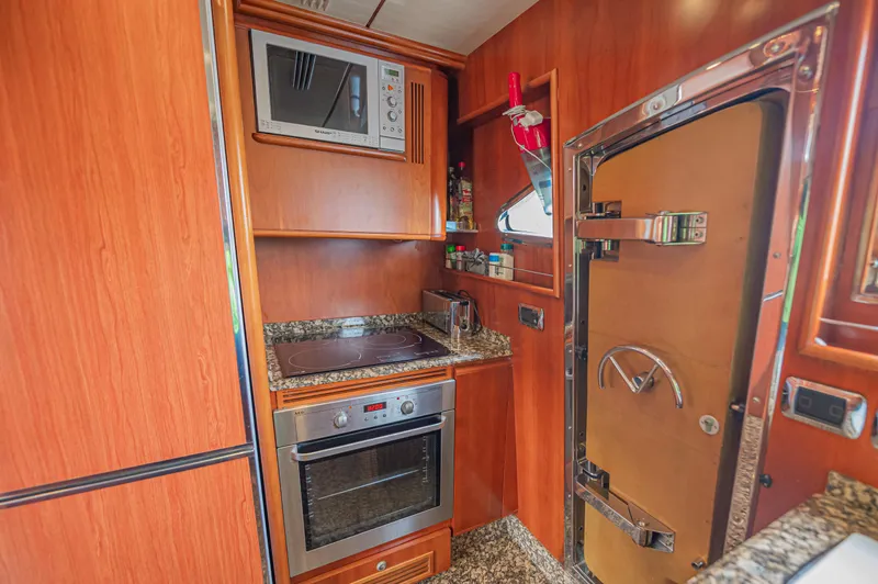 Isabella K Yacht Photos Pics Luxurious kitchen interior of 2002 Astondoa 72 GLX yacht with modern appliances.