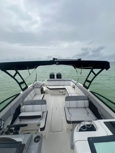  Yacht Photos Pics 2017 Sea Ray SDX 290 Outboard boat with spacious seating on calm water.