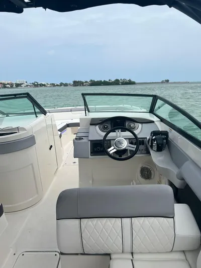  Yacht Photos Pics 2017 Sea Ray SDX 290 Outboard boat interior with steering wheel, on open water.