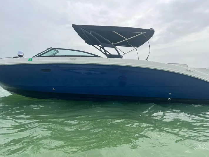  Yacht Photos Pics 2017 Sea Ray SDX 290 Outboard boat with blue hull on calm water.