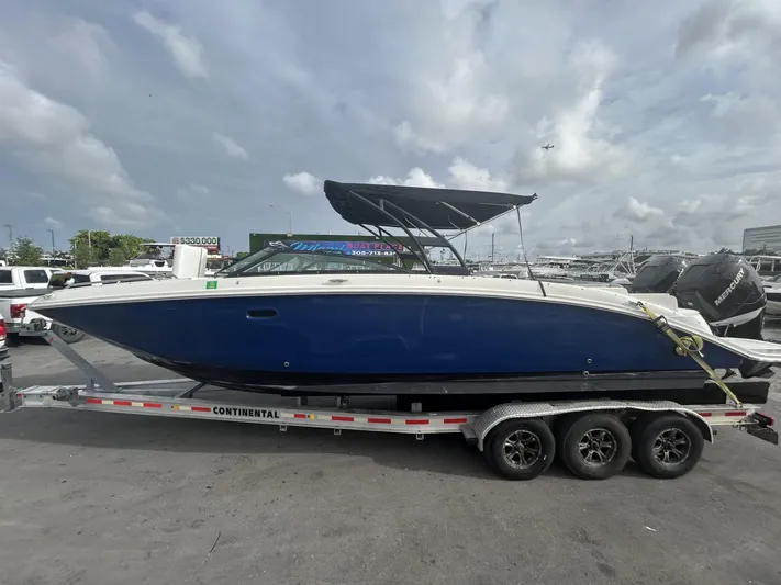  Yacht Photos Pics 2017 Sea Ray SDX 290 Outboard boat on trailer, blue hull, parked outdoors.