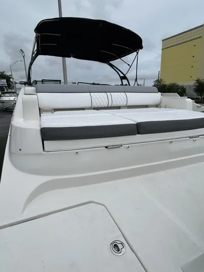  Yacht Photos Pics 2017 Sea Ray SDX 290 Outboard boat with cushioned seating and canopy, docked outdoors.