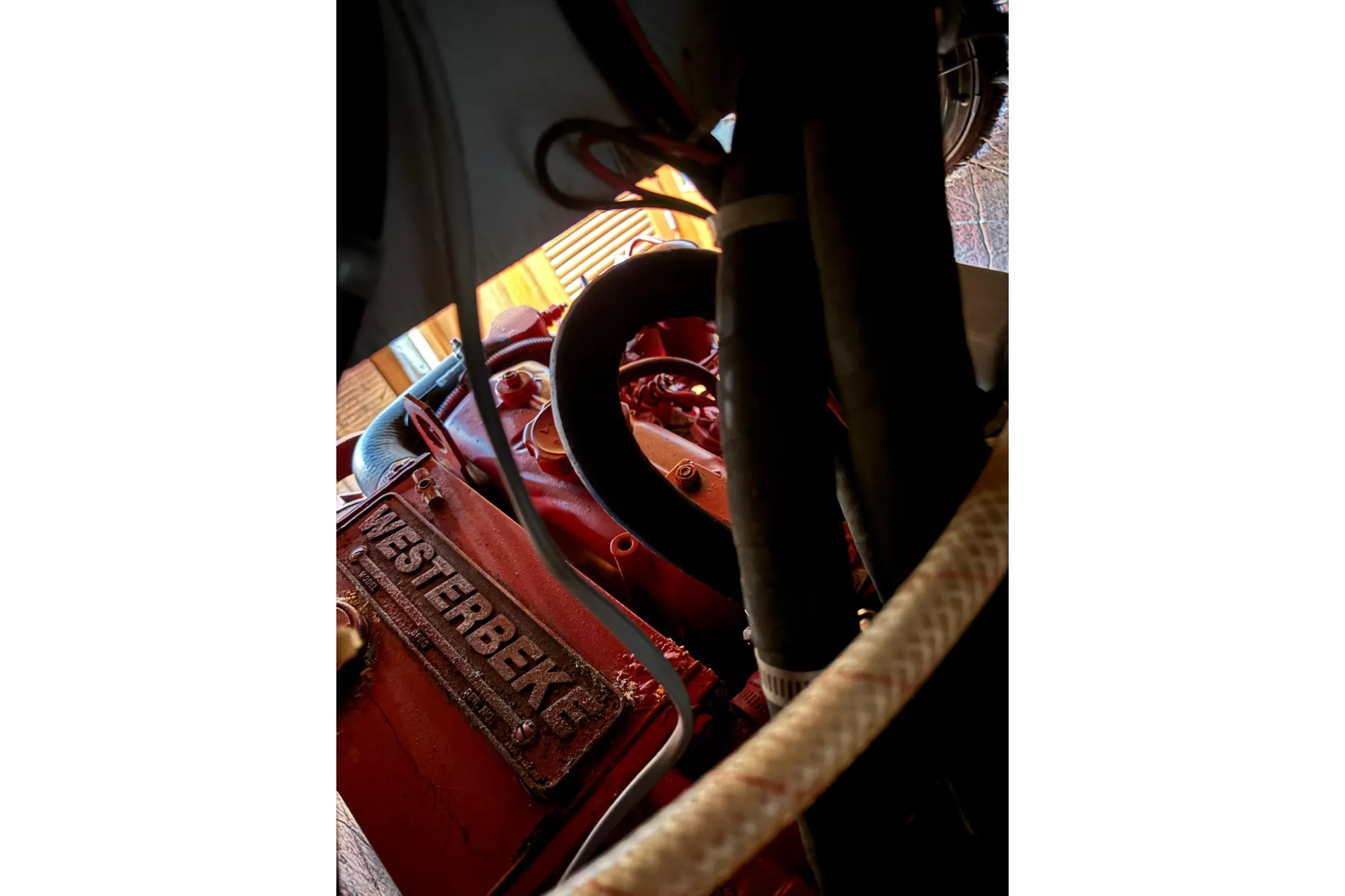Engine compartment of a 1985 Mason 33 sailboat featuring a Westerbeke engine.