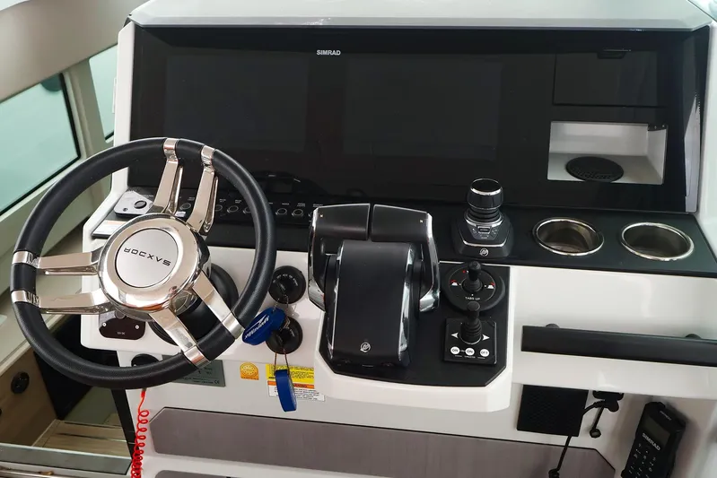  Yacht Photos Pics 2023 Saxdor 320 GTO helm with steering wheel, controls, and Simrad display.