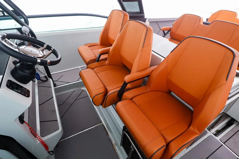  Yacht Photos Pics 2023 Saxdor 320 GTO interior with orange seats and modern steering console.